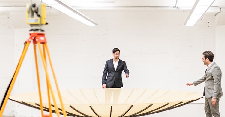 Umbra Lab founders Gabe Dominocielo and David Langan look at the bottom of the company's innovative parabolic antenna, the first time this photo has been released publicly.