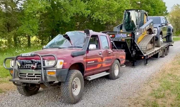 A 1989 Hilux pulling a 30,000-lb gooseneck trailer before being shipped off to Moab - Credit: WhistlinDiesel